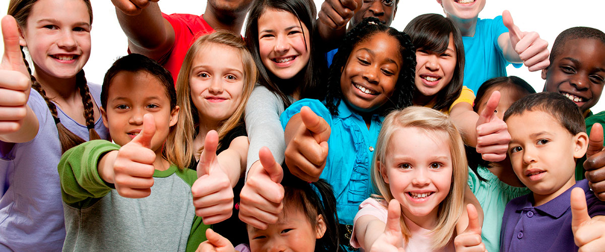 Kids smiling with thumbs up